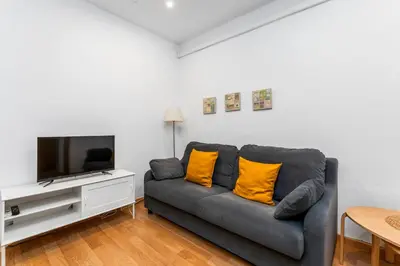a bedroom with a bed and wooden cabinets at Mediterranean and connected in Sant Adria de Besos