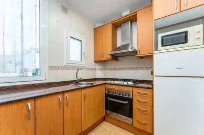 a living room with a dining table and a tv at Mediterranean and connected in Sant Adria de Besos