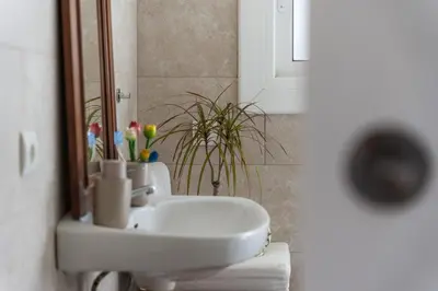 a bathroom with a white sink and a mirror at Casa Olivella #7 by Happy Houses Barcelona in Olivella