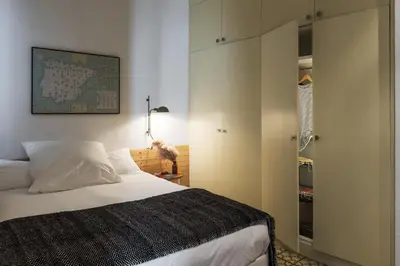 a bedroom with a large bed and a closet at Brummell Apartments Gracia in Barcelona