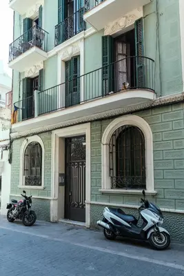 two motorcycles parked in front of a building at Brummell Apartments Gracia in Barcelona