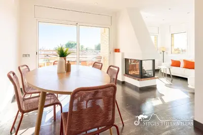 a living room with a fireplace and a tv at Modern Apartment Lily close to beach with Com Pool and AC in Sitges