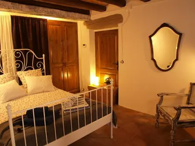 a bedroom with a bed and a mirror and a chair at Music room in Montserrat in Castellbell i Vilar
