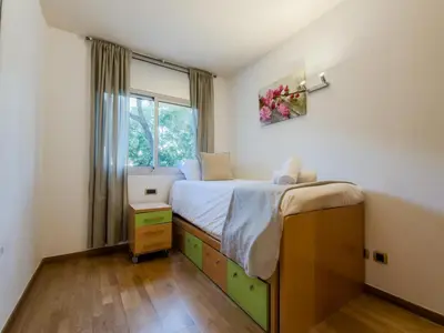 a small bedroom with a bed and a window at Bed BCN Vila Olímpica. in Barcelona
