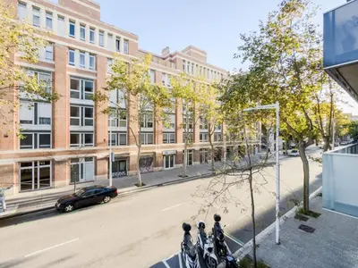 a row of motorcycles parked on a city street at Bed BCN Vila Olímpica. in Barcelona