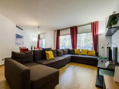 a living room with a brown couch and yellow pillows at Bed BCN Vila Olímpica. in Barcelona