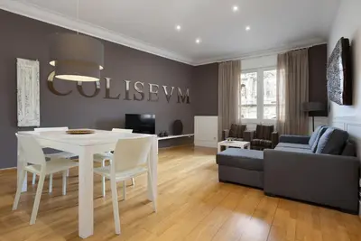 a living room with a white table and a couch at Enjoybcn Coliseum Apartments in Barcelona