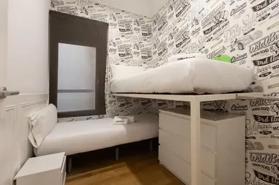 a bedroom with a bunk bed and a mirror at Enjoybcn Coliseum Apartments in Barcelona