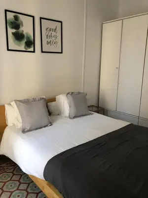a bedroom with a large white bed with two pillows at 1 Casual Apartments in Barcelona