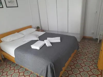 a bedroom with a large bed with two towels on it at 1 Casual Apartments in Barcelona