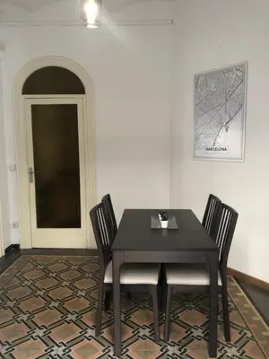 a dining room with a black table and chairs at 1 Casual Apartments in Barcelona