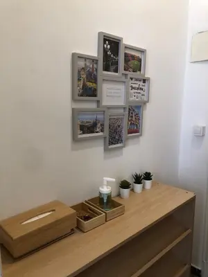 a wooden table with pictures on a wall at 1 Casual Apartments in Barcelona