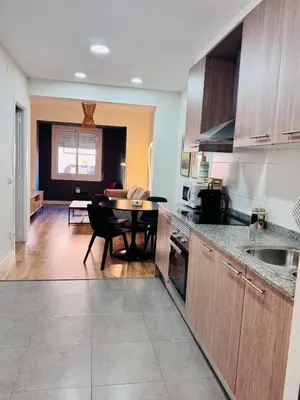 a kitchen with a table and a dining room at Apartamento Lauda 2 in Hospitalet de Llobregat