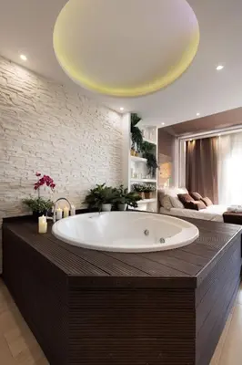 a bathroom with a large white tub and candles at Perfect Romantic Getaway Cozy Retreat with Jacuzzi in Barcelona