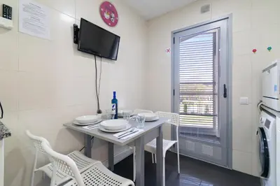 a small dining room with a table and chairs at Carol Suites Fira Barcelona Habitaciones privadas en apartamento in Hospitalet de Llobregat