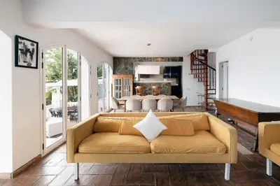 a living room with a couch and a table at Exclusive Villa with Private Pool in Sitges in Sitges