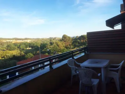 a group of chairs under a red canopy on a patio at House for 8-14 people 25 min from Barcelona, Montserrat, Sitges, Penedes, Sant Cugat in Abrera