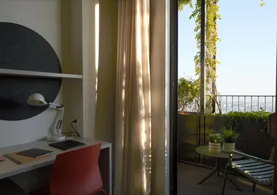 a balcony with a table and chairs and plants at aparto Diagonal Suites in Esplugues de Llobregat