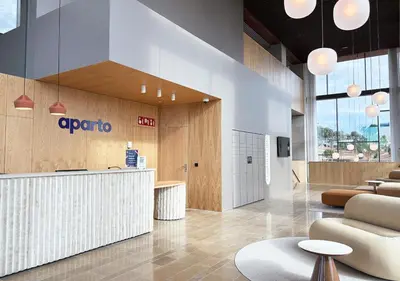 an office lobby with a reception counter and chairs at aparto Diagonal Suites in Esplugues de Llobregat