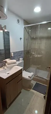 a bathroom with a shower and a toilet and a sink at Studio B in Santa Coloma de Gramanet