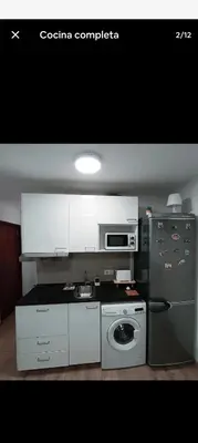 a kitchen with a stove and a refrigerator at Studio B in Santa Coloma de Gramanet