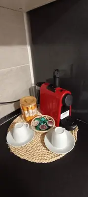 a table with two plates and a red coffee maker at Studio B in Santa Coloma de Gramanet