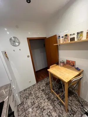 a kitchen with a wooden table in a room at HABITACIÓN barcelona in Barcelona