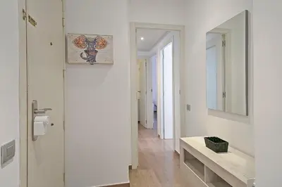 a white bathroom with a sink and a mirror at Dialez Holidays - Sant Nicasi in Gavà