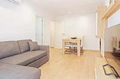 a living room with a couch and a table at Dialez Holidays - Colomeres in Gavà