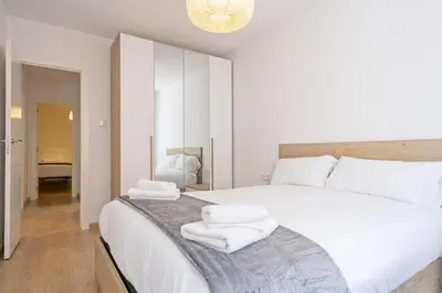 a bedroom with a large white bed with towels on it at Dialez Holidays - Colomeres in Gavà
