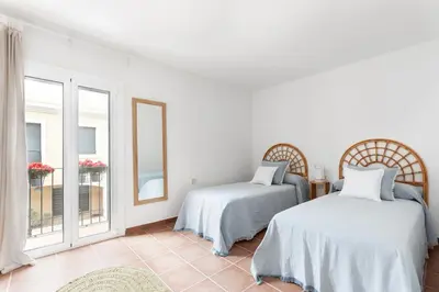 a white room with two beds and a window at Casa Rosari I - Jardín & Parking Privado in Vilassar de Mar