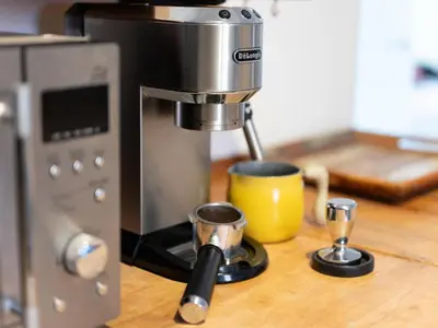 a coffee machine sitting on a counter with two cups at Cosy Sants Apartment in Barcelona