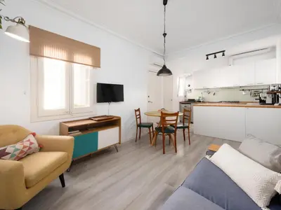 a living room with a couch and a table at Cosy Sants Apartment in Barcelona