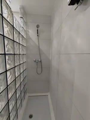 a white bathroom with a shower with a shower at Apartamento en Montgat - Serenity Stays in Montgat