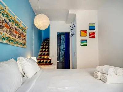 a bedroom with a white bed with towels on it at Las Terracitas Apartment by Hello Homes Sitges in Sitges