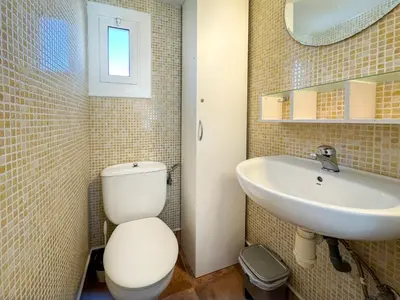 a bathroom with a toilet and a sink at Las Terracitas Apartment by Hello Homes Sitges in Sitges