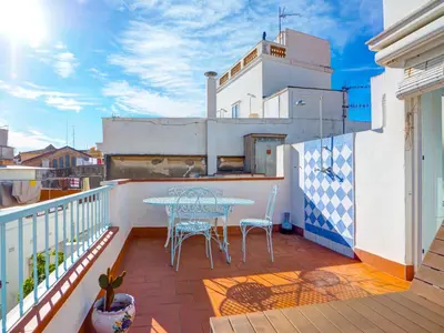a patio with a table and chairs on a balcony at Las Terracitas Apartment by Hello Homes Sitges in Sitges