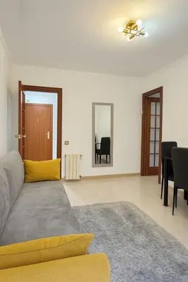 a living room with a couch and a ceiling fan at New renovate apartment near of the sea in Barcelona