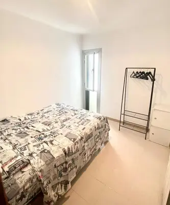a bedroom with a bed and a mirror in it at New renovate apartment near of the sea in Barcelona