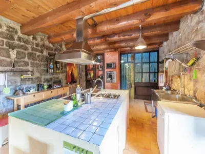 a kitchen with a counter top in a room at Farmhouse near Barcelona with Pool in Marganell
