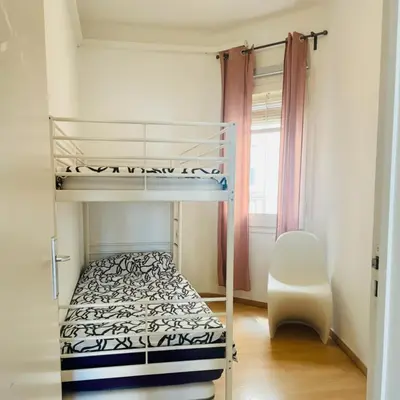 a bedroom with a bunk bed and a chair at Modern and Elegant Barcelona Apartment in Barcelona