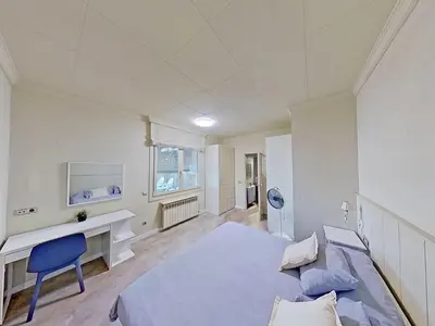 a bedroom with a bed and a desk and a chair at Premium Habitat Les Villes in Arenys de Mar