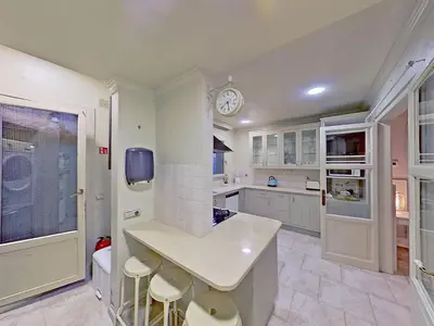a kitchen with a counter and a clock on the wall at Premium Habitat Les Villes in Arenys de Mar