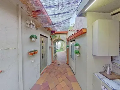 an empty hallway of a building with plants on the ceilings at Premium Habitat Les Villes in Arenys de Mar