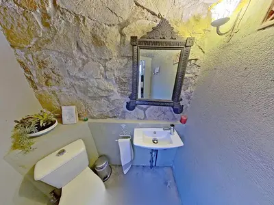 a bathroom with a sink and a toilet and a mirror at Premium Habitat Les Villes in Arenys de Mar