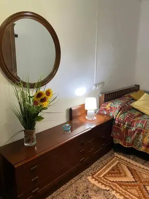 a bedroom with a table with a mirror and a bed at Casa EMILIO in Olesa de Montserrat