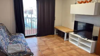 a living room with a tv and a couch and a table at Calle Ramon Berenguer Iv, 13, Sant Pere de Ribes barcelona 08812 in Vilanova i la Geltrú