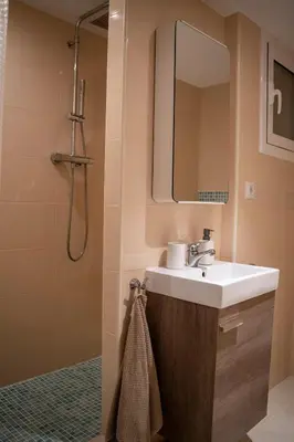 a bathroom with a sink and a shower with a mirror at Apartment in Ciutat Vella Born in Barcelona