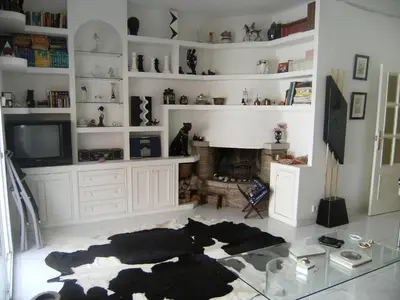 a living room with a fireplace and a tv at Blanca Subur in Sitges