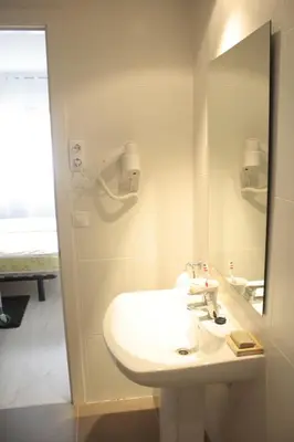 a bathroom with a white sink and a mirror at 3-Apartament full equiped, next to Mobile Congres in Hospitalet de Llobregat